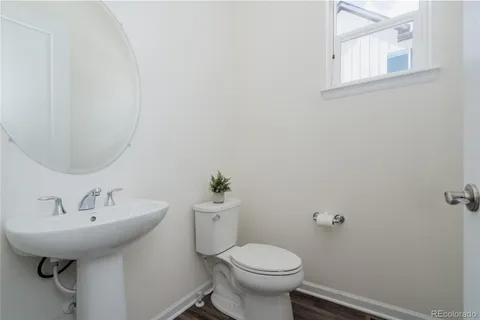 a bathroom with a sink toilet and a mirror