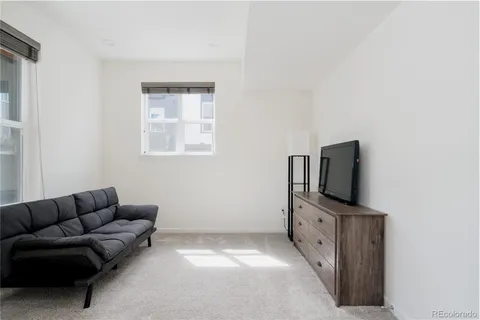 a living room with furniture and flat screen tv