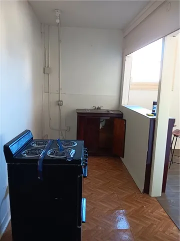 a utility room with wooden floor washer and dryer