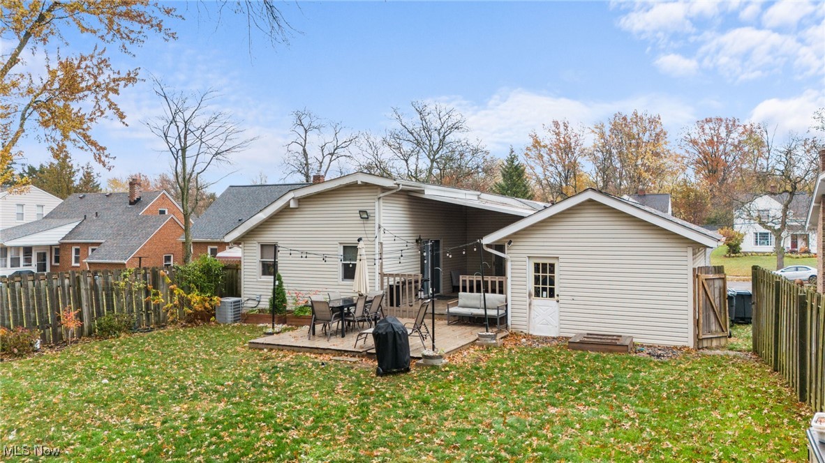 1620 Sunview Road Cleveland, OH 44124 - Photo 26 of 36 Rear view of house featuring central AC unit, a lawn, and a patio