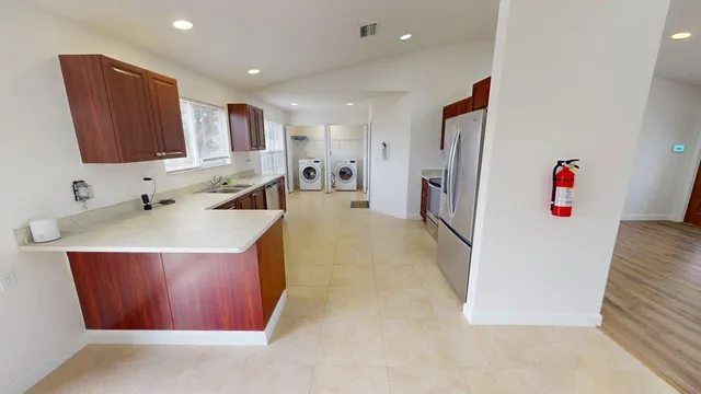 a kitchen with a sink refrigerator and microwave