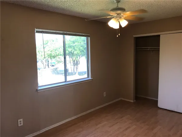 a view of room with window and ceiling fan