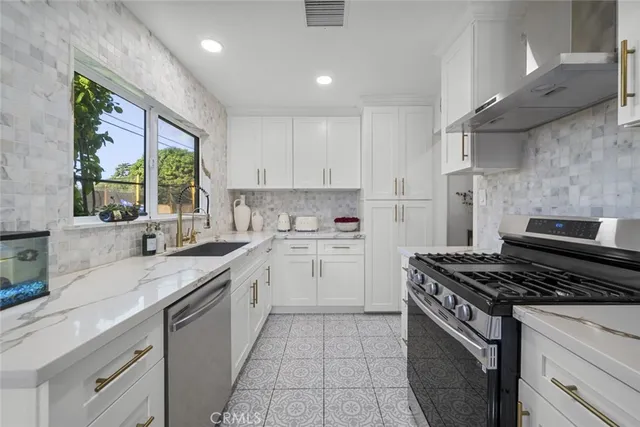 a kitchen with a stove a sink and a refrigerator
