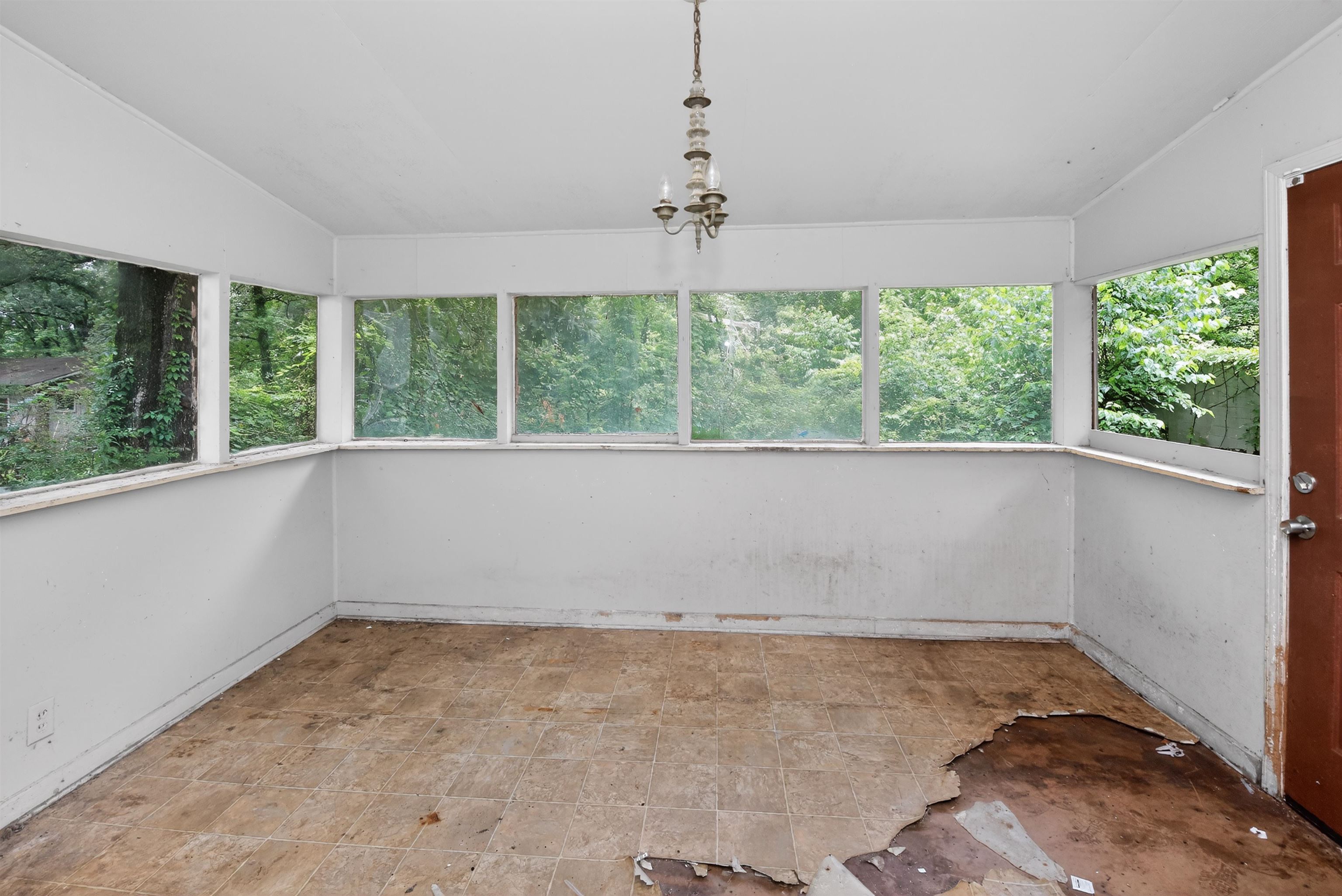 810 Hale Road Memphis, TN 38116 - Photo 30 of 30 Sunroom featuring multiple windows, a ceiling-mounted light fixture, and an exterior door