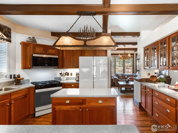 a kitchen with a sink appliances and cabinets