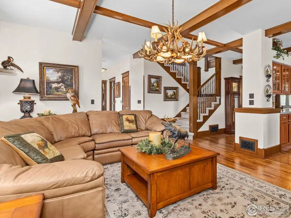 a living room with furniture and a chandelier