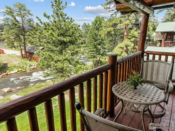 a view of a balcony with table and chairs