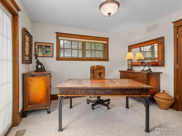 a room with furniture pool table and window