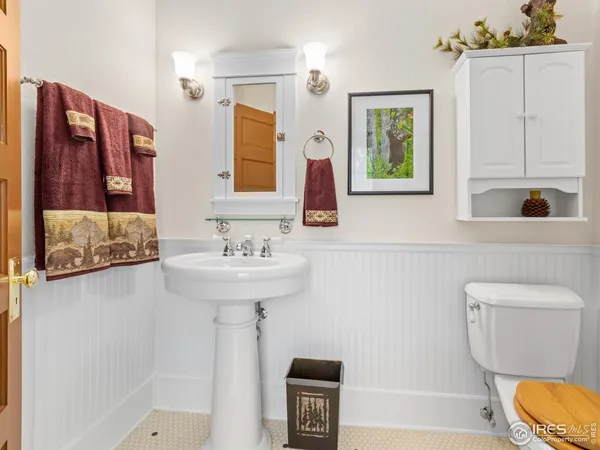 a bathroom with a sink a toilet and mirror