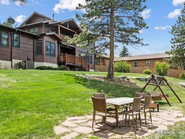a view of a house with backyard sitting area and garden