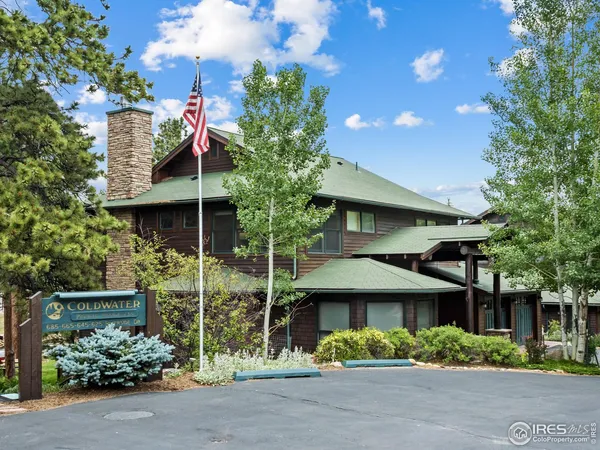 a view of a house with lots of trees and plants