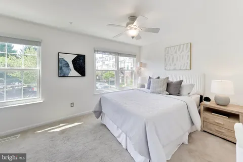a spacious bedroom with a bed and a window