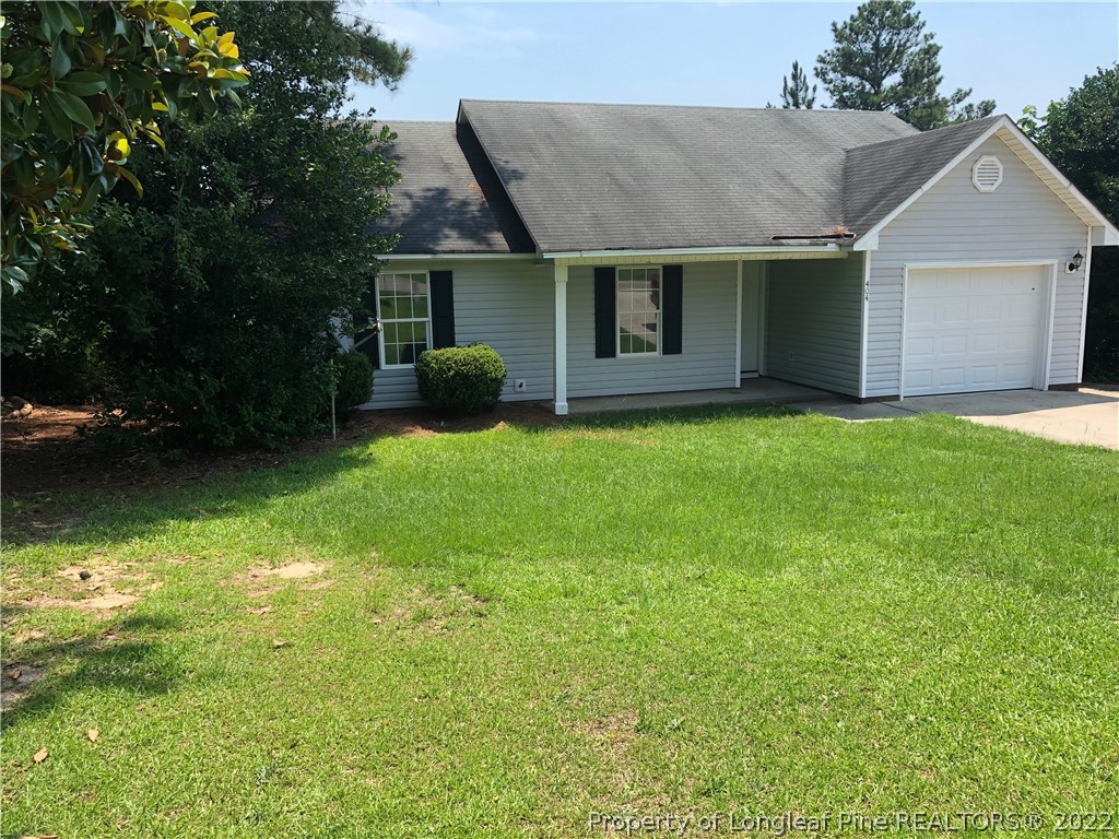 450 Main Street Lillington, NC 27546 - Photo 1 of 11 a view of a house with a yard and a patio