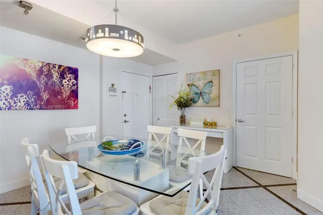 a view of a dining room with furniture a chandelier and wooden floor