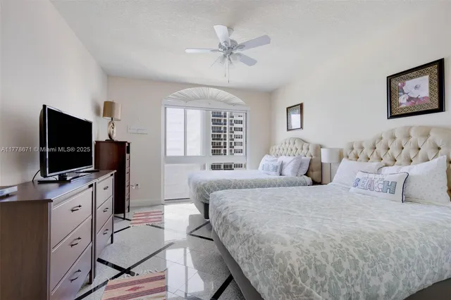 a bedroom with a large bed and a flat screen tv