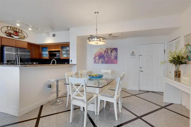 a view of a kitchen with granite countertop a table and chairs in it