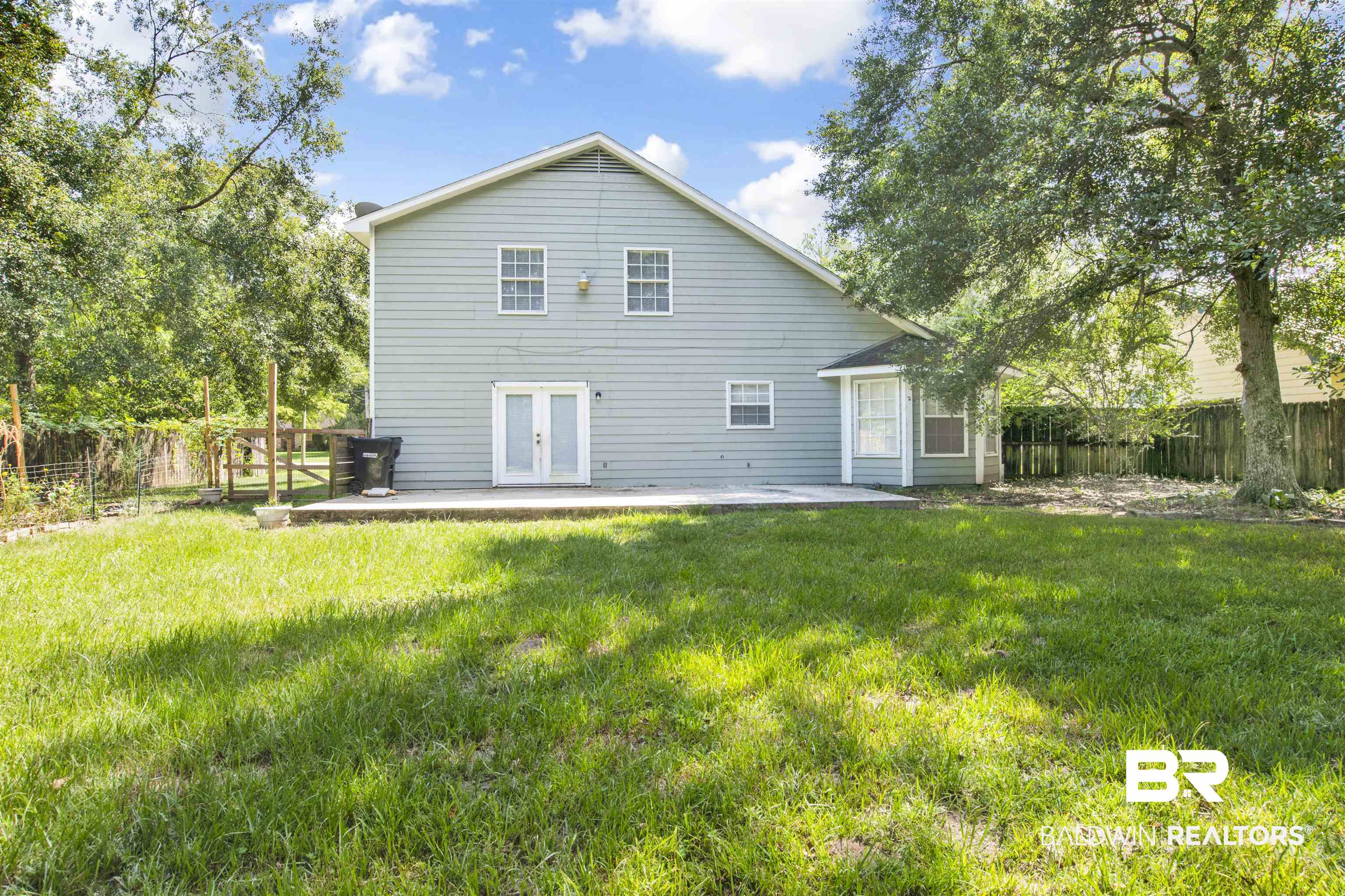 5480 Country Club Boulevard Theodore, AL 36582 - Photo 35 of 36 Back of property with a lawn, a patio, and french doors