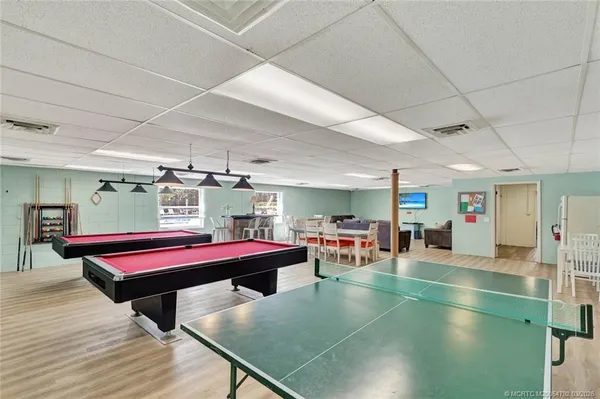 a living room with furniture a table and wooden floor