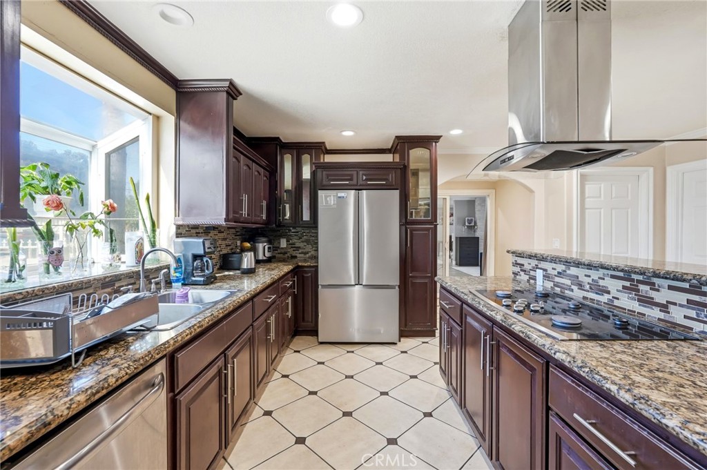 8630 Sharp Avenue Sun Valley, CA 91352 - Photo 12 of 62 a kitchen with stainless steel appliances granite countertop a sink stove and refrigerator