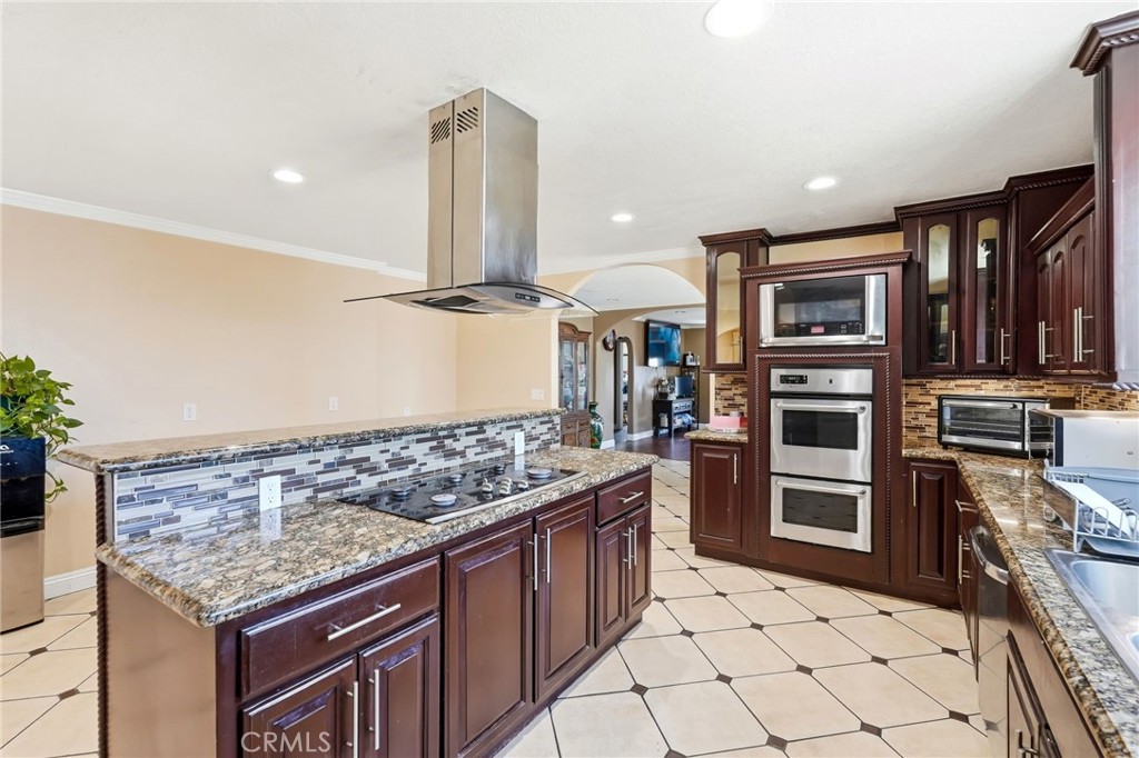 8630 Sharp Avenue Sun Valley, CA 91352 - Photo 13 of 62 a kitchen with stainless steel appliances granite countertop a stove a sink and a refrigerator