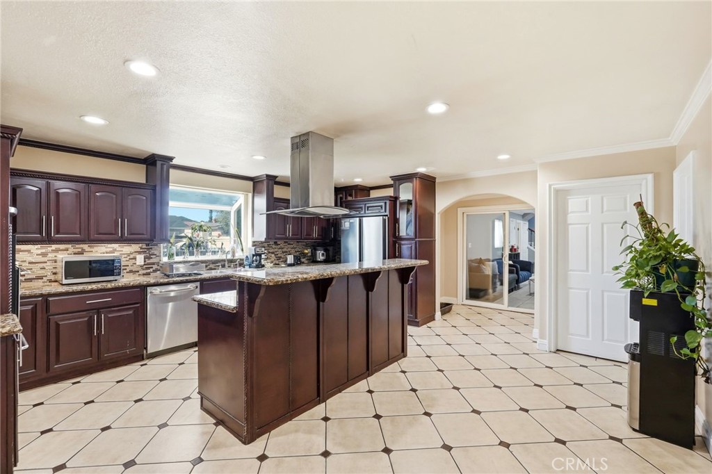 8630 Sharp Avenue Sun Valley, CA 91352 - Photo 14 of 62 a kitchen with stainless steel appliances kitchen island granite countertop a refrigerator and a sink