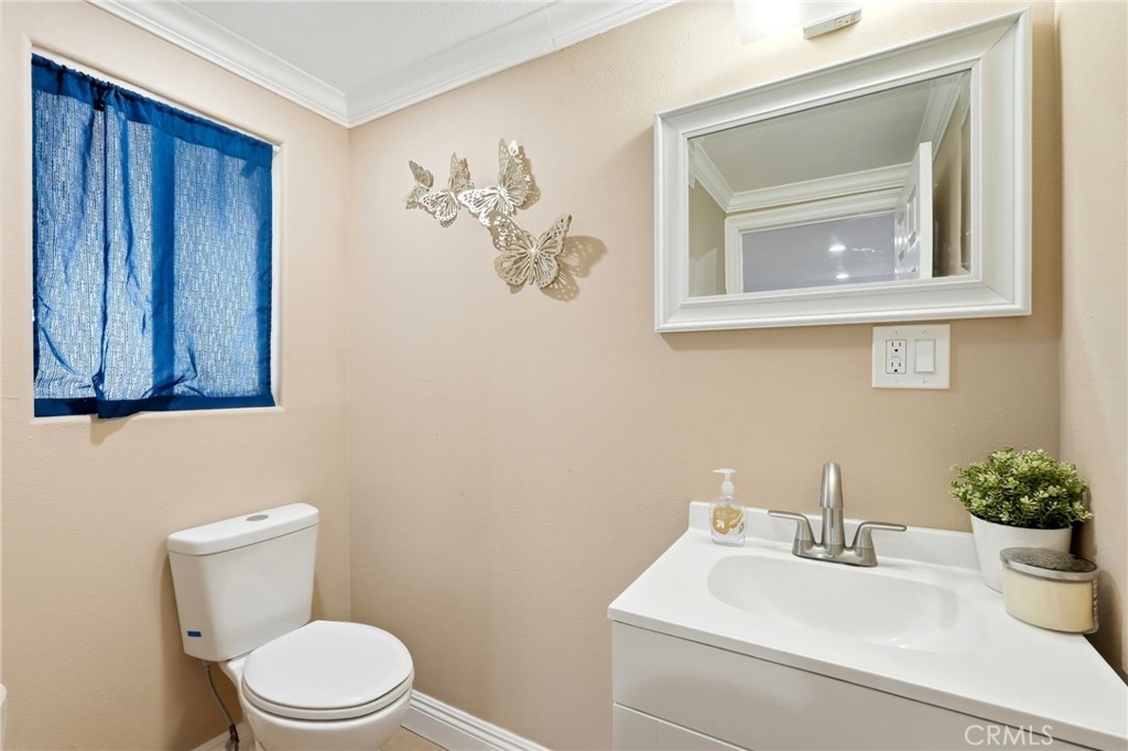 8630 Sharp Avenue Sun Valley, CA 91352 - Photo 22 of 62 a bathroom with a toilet sink and mirror