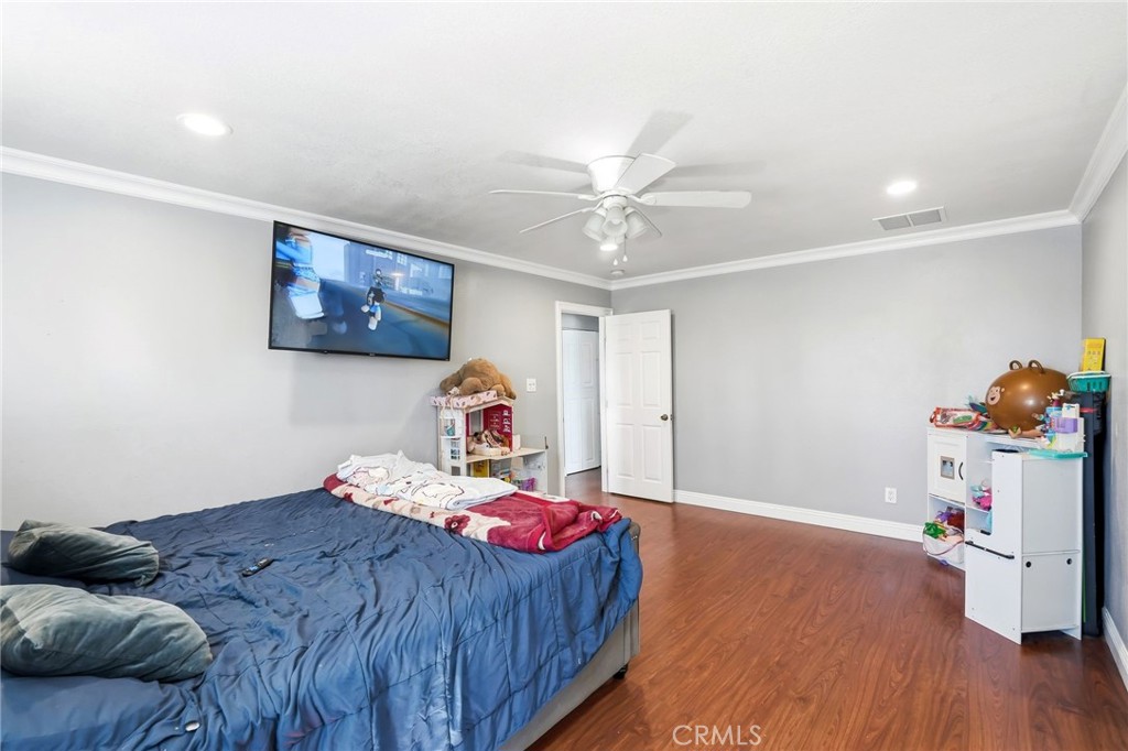 8630 Sharp Avenue Sun Valley, CA 91352 - Photo 25 of 62 a bedroom with a bed and a wooden floor