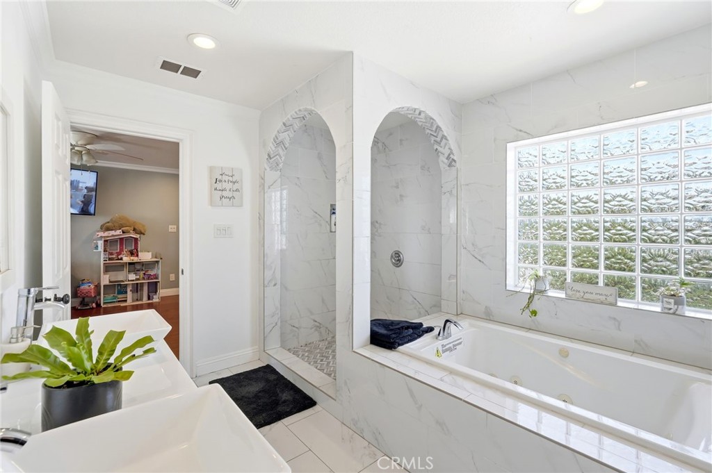 8630 Sharp Avenue Sun Valley, CA 91352 - Photo 28 of 62 a bathroom with a tub a sink and a shower