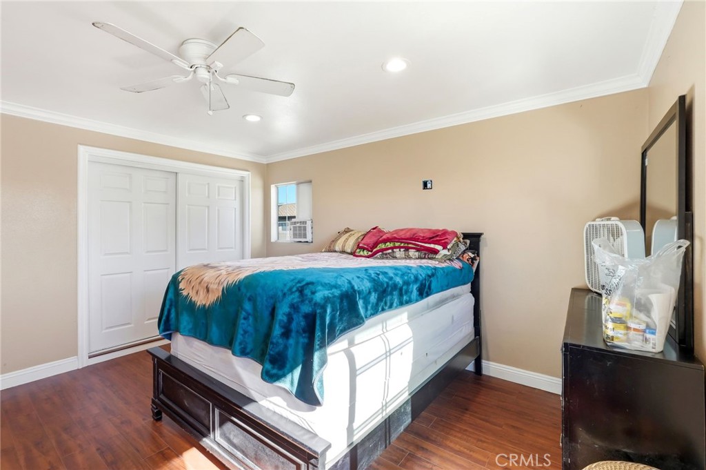 8630 Sharp Avenue Sun Valley, CA 91352 - Photo 30 of 62 a bedroom with a bed and dresser with wooden floor