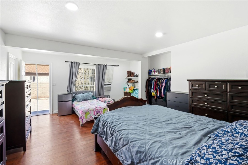 8630 Sharp Avenue Sun Valley, CA 91352 - Photo 31 of 62 a bedroom with bed and wooden floor