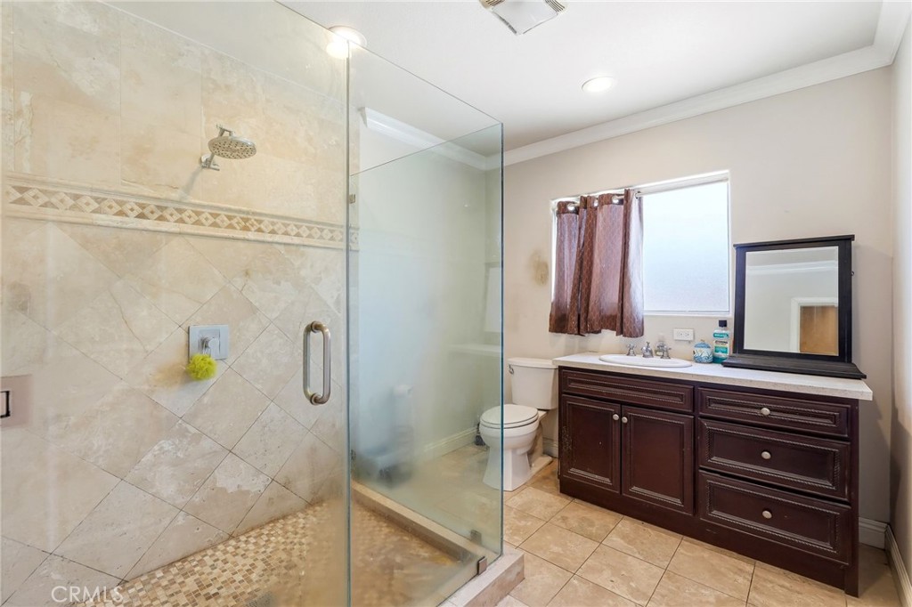 8630 Sharp Avenue Sun Valley, CA 91352 - Photo 42 of 62 a bathroom with a granite countertop sink a toilet and shower