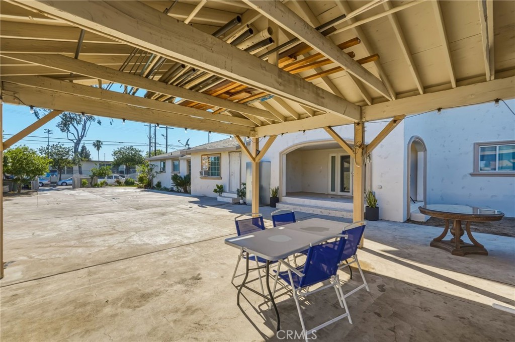 8630 Sharp Avenue Sun Valley, CA 91352 - Photo 54 of 62 a view of a patio with table and chairs with wooden floor and fence