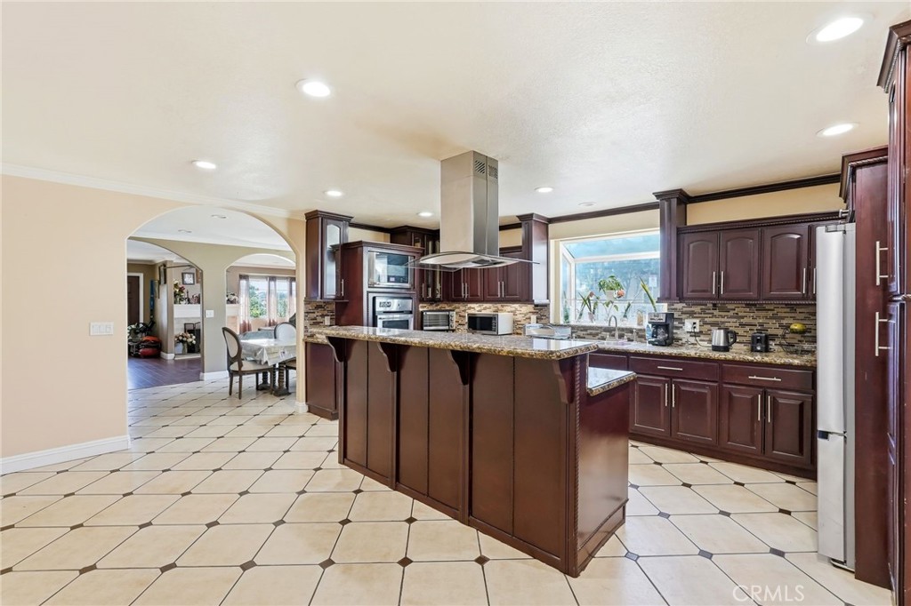8630 Sharp Avenue Sun Valley, CA 91352 - Photo 10 of 62 a kitchen with stainless steel appliances kitchen island granite countertop a sink and cabinets