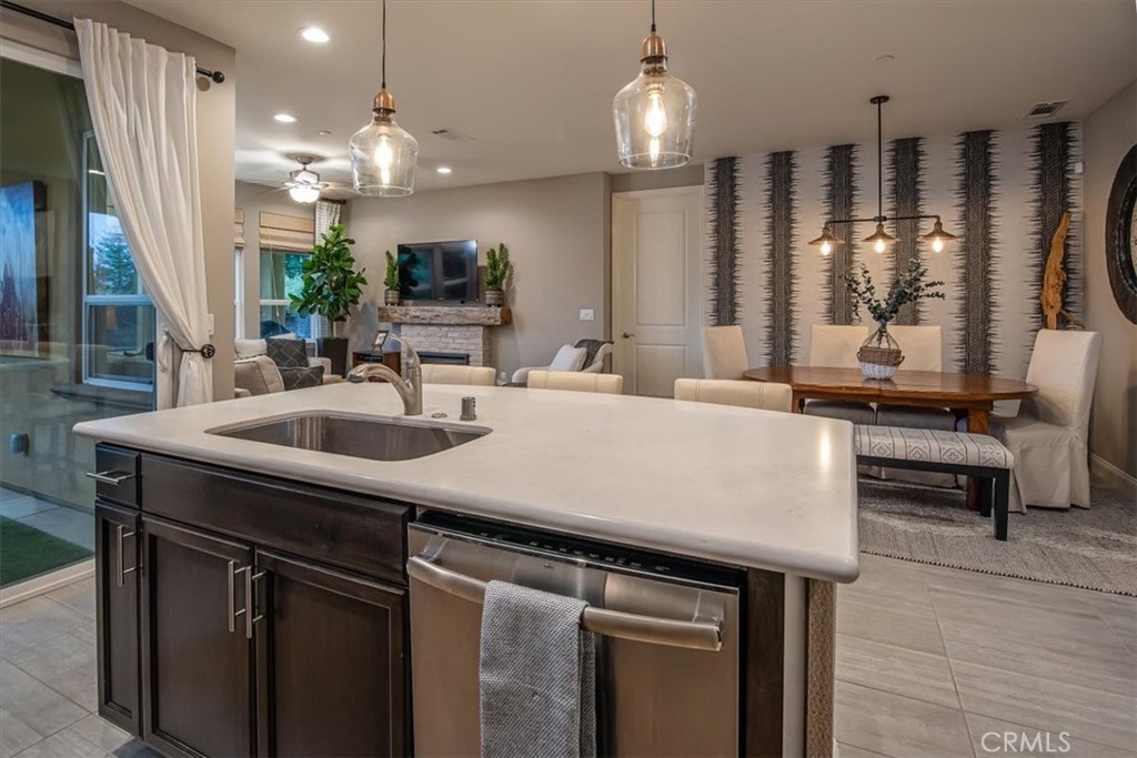1170 Spring Azure Way, Unit 45 Nipomo, CA 93444 - Photo 12 of 43 a kitchen with a sink a counter and chairs