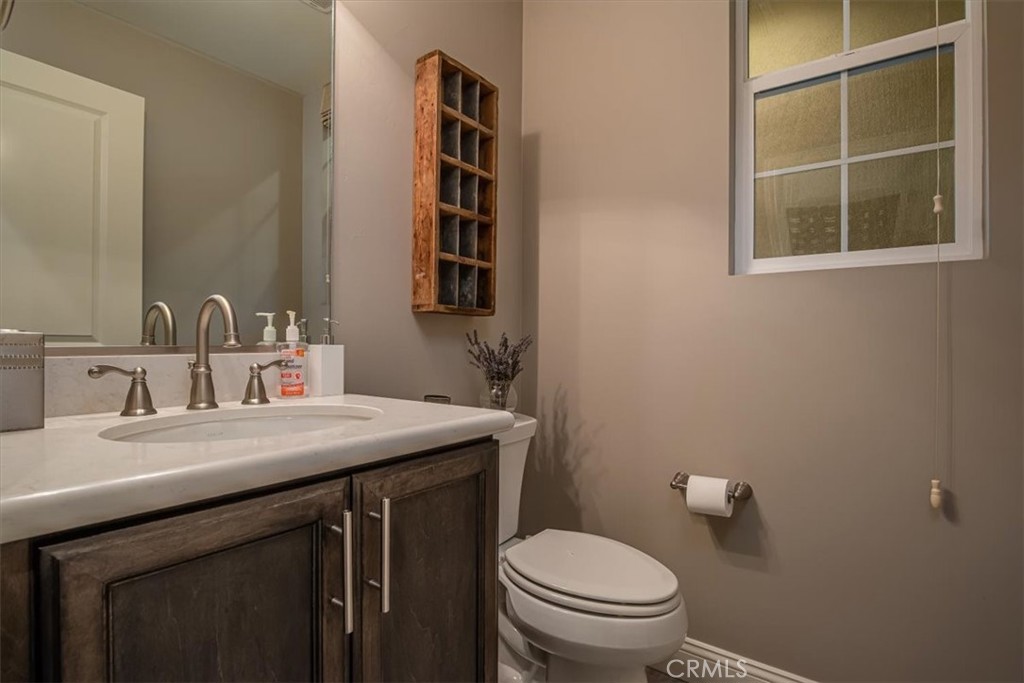 1170 Spring Azure Way, Unit 45 Nipomo, CA 93444 - Photo 15 of 43 a bathroom with a sink a toilet and a mirror