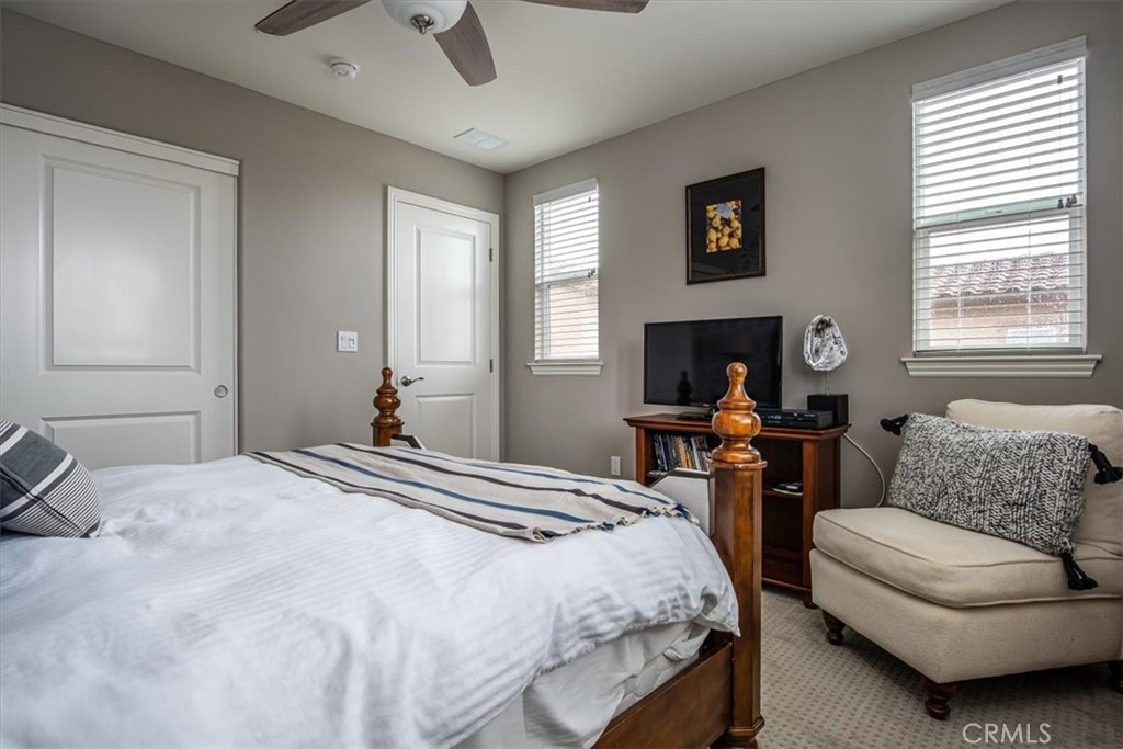 1170 Spring Azure Way, Unit 45 Nipomo, CA 93444 - Photo 10 of 43 a bedroom with a bed and wooden floor