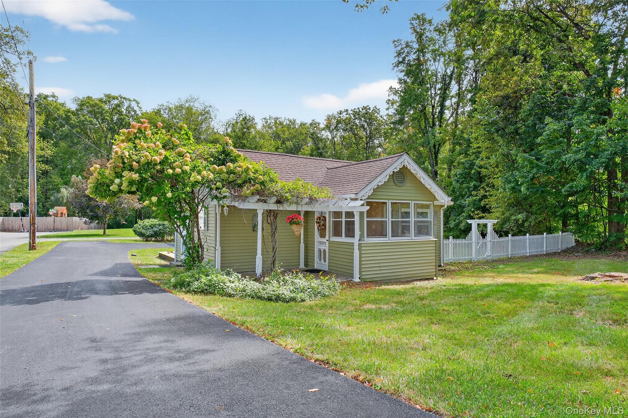 a front view of house with yard and green space