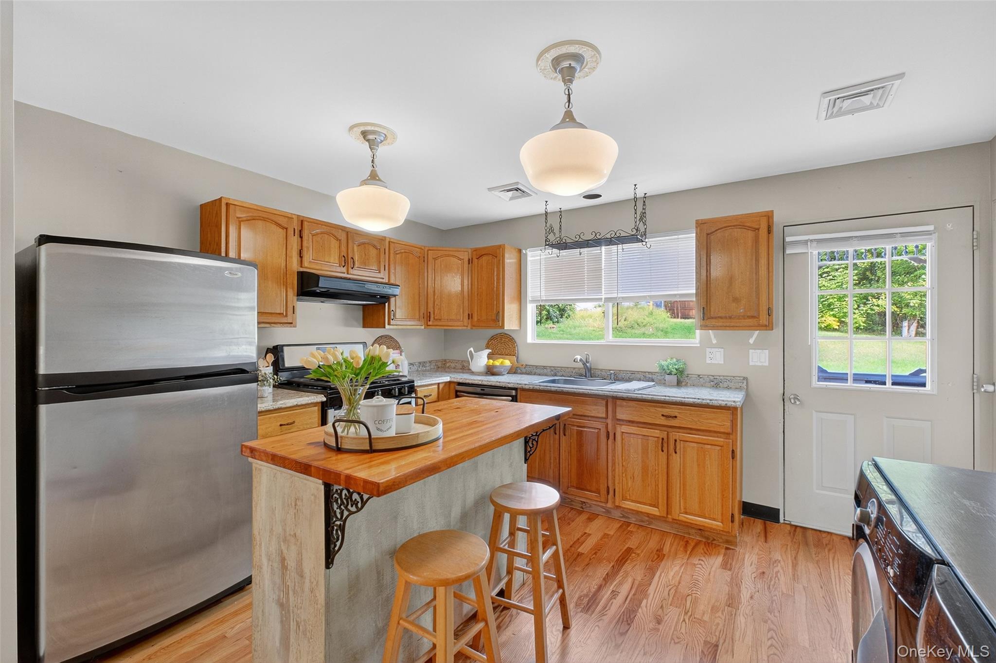 101 Osborne Hill Road Fishkill, NY 12524 - Photo 7 of 19 a kitchen with stainless steel appliances a refrigerator a sink a stove and white cabinets