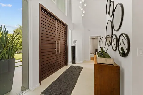 a spacious bedroom with a bed and a large window