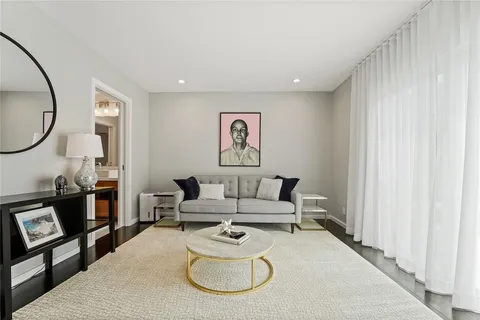 a kitchen with stainless steel appliances a refrigerator a sink dishwasher with a dining table and chairs