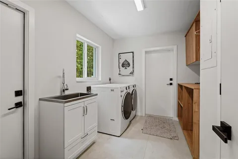 a bathroom with a double vanity sink a mirror and a bathtub