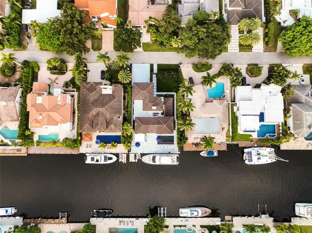 a view of a house with a backyard and a tree