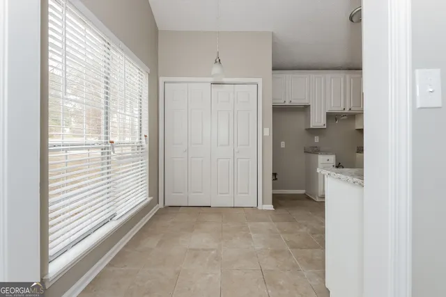 a view of a kitchen with a sink and refrigerator