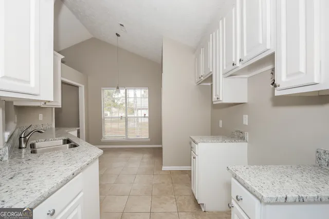 a kitchen with a sink stove and cabinets