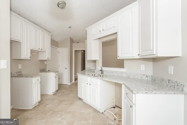 a kitchen with a sink stove and cabinets