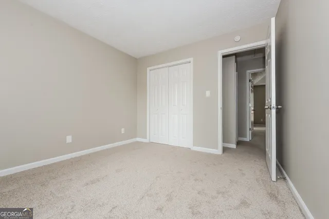 a view of an empty room and closet