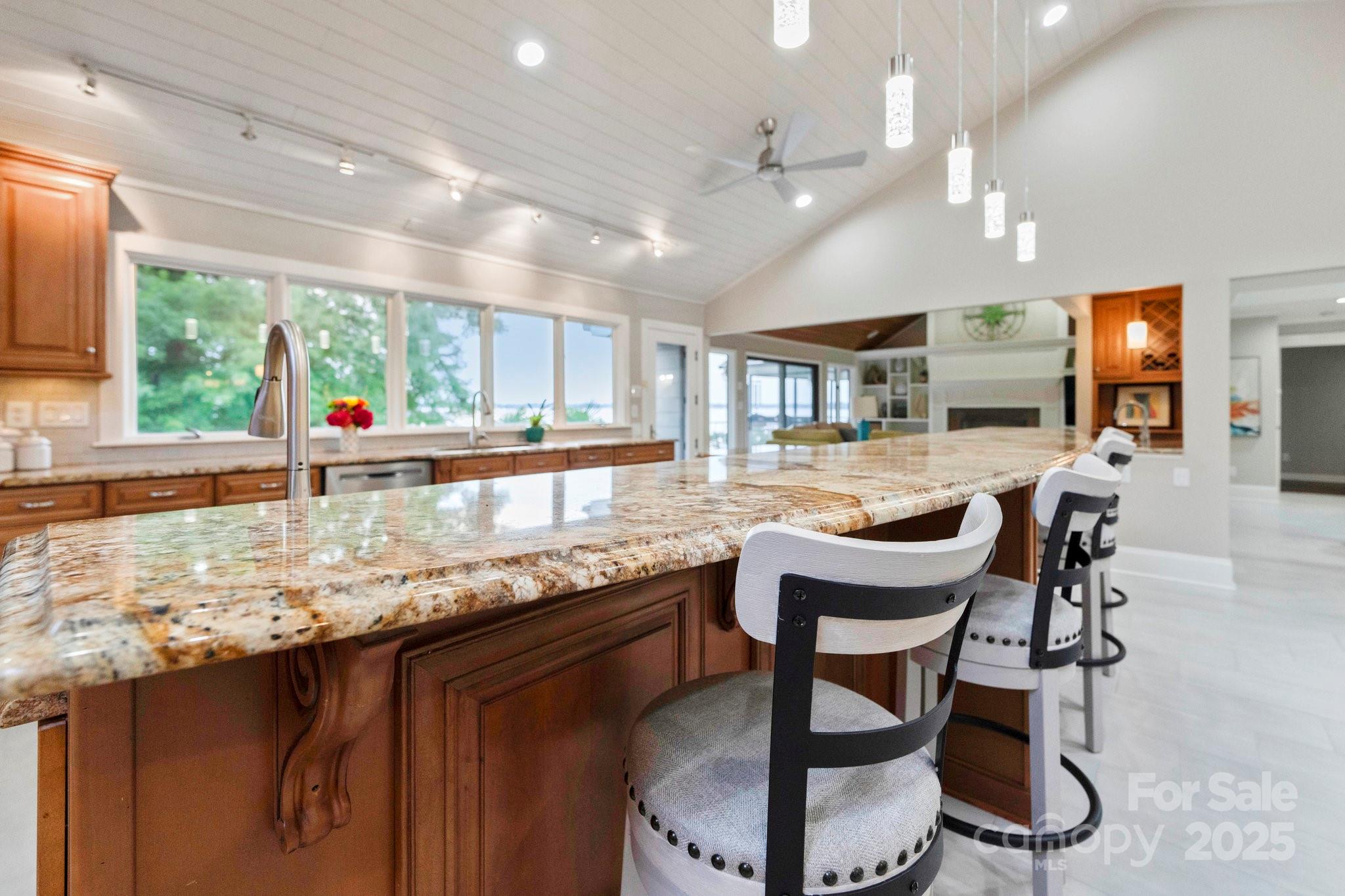 22501 John Gamble Road Cornelius, NC 28031 - Photo 12 of 47 a kitchen with granite countertop lots of counter top space dining table and stainless steel appliances