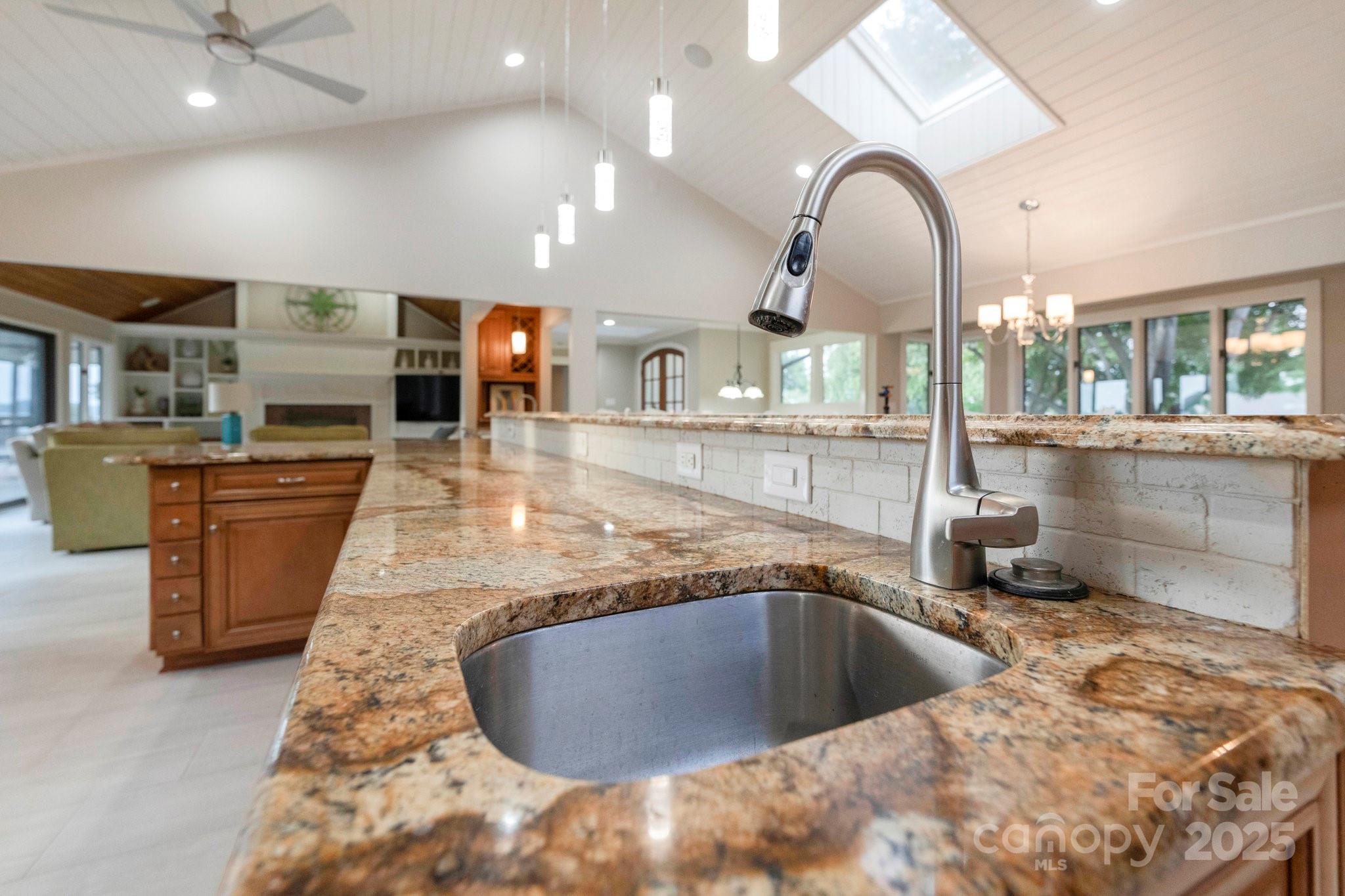 22501 John Gamble Road Cornelius, NC 28031 - Photo 19 of 47 a view of a kitchen with kitchen island a large counter top a sink stainless steel appliances and cabinets