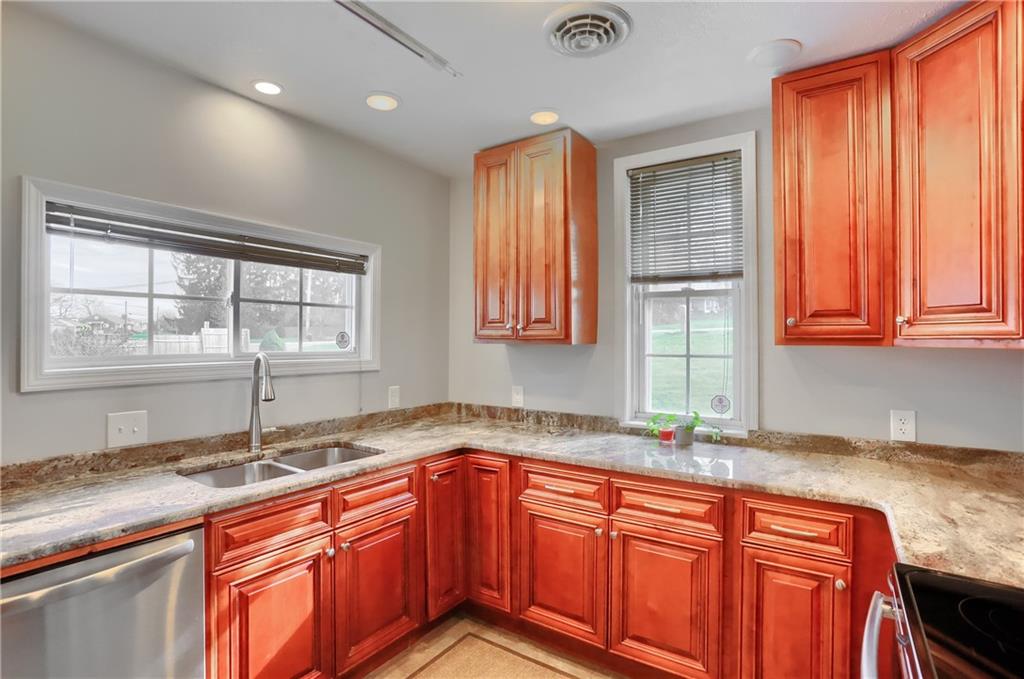 110 Oakville Road Beaver Falls, PA 15010 - Photo 18 of 48 a kitchen with stainless steel appliances granite countertop wooden cabinets a sink and a window