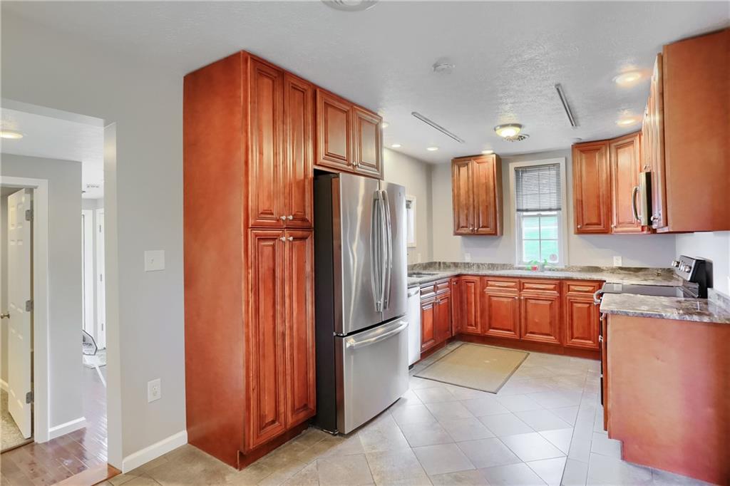 110 Oakville Road Beaver Falls, PA 15010 - Photo 19 of 48 a kitchen with stainless steel appliances granite countertop a refrigerator and a sink